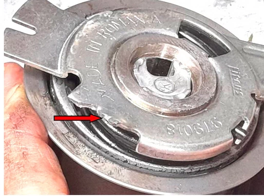 Фото 4. Повреждённая упорная часть кронштейна ролика – показано красной стрелкой